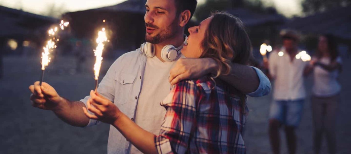 happy couple holding sparklers