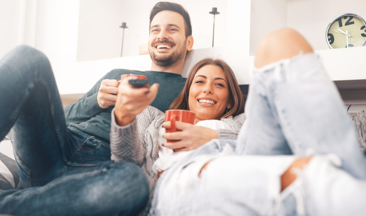 young couple watching cable tv