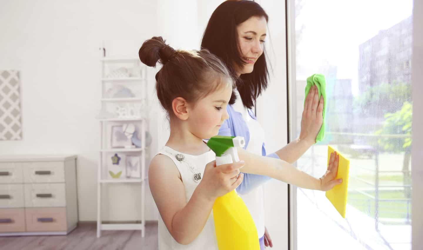 mother and daughter washing windows