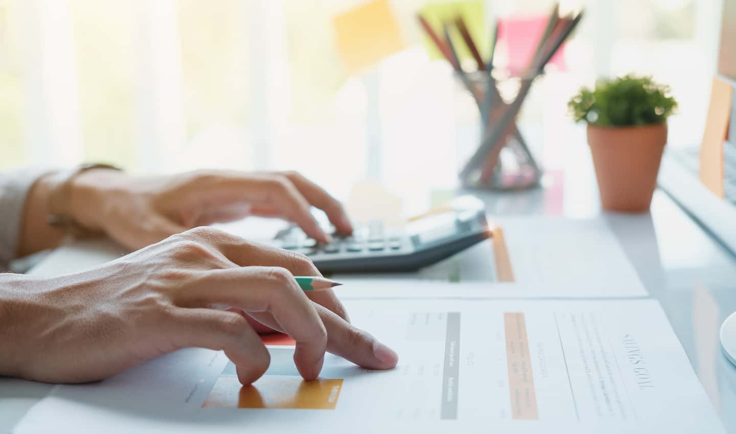 woman's hands calculating business expenses