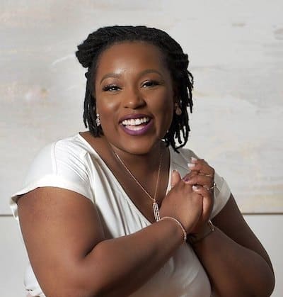 Felicia Kelly wearing a white shirt and smiling