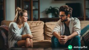 A young couple having a serious discussion about their finances while sitting on the couch