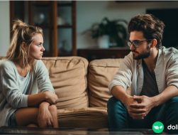 A young couple having a serious discussion about their finances while sitting on the couch