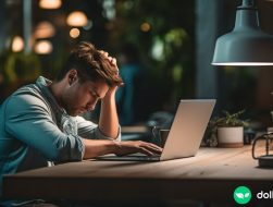 A stressed out freelancer sitting at his desk, contemplating if he should accept another gig for no pay.