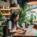 A Google software engineer working on her laptop in a lounge with a lot of plants.