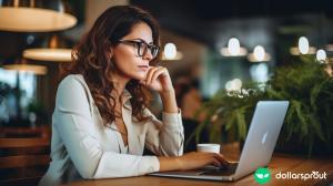 A well dressed female wearing glasses, working on her laptop. She is trying to find clients online.