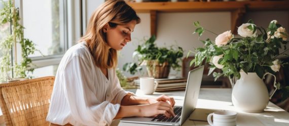 A woman sitting at her laptop about to start working on her blog.