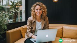 A woman sitting on a leather couch with her Macbook, smiling at the camera. She is a freelance writer.