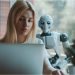 robot overlooks woman on laptop