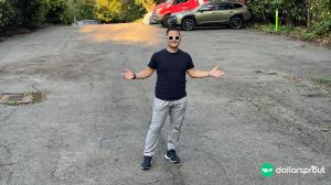 Justin Cambra posing in his vacant lot that he listed on Neighbor.com