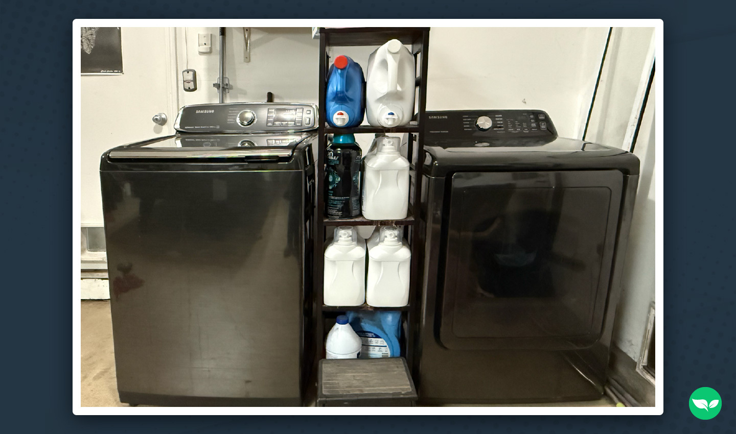 Melia Long’s laundry setup with a washer, dryer, and shelves stocked with detergent in a home garage