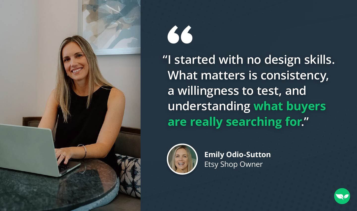 Emily Odio-Sutton smiling while working at a round black table with her laptop