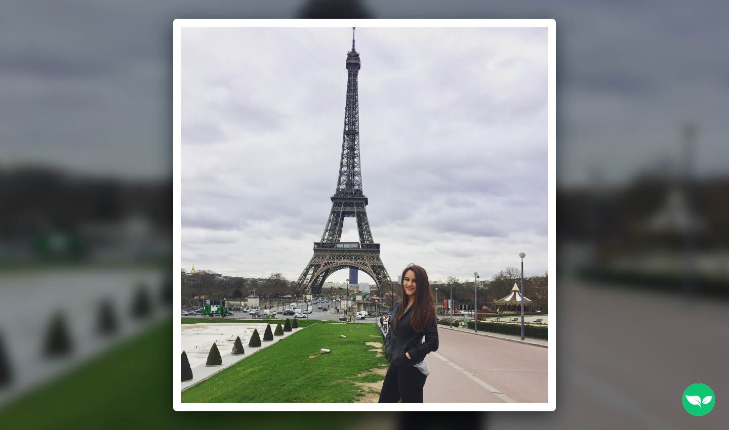 Madison Krigbaum standing in front of the Eiffel Tower in Paris, featured in the first photo ever posted to her travel blog’s Instagram