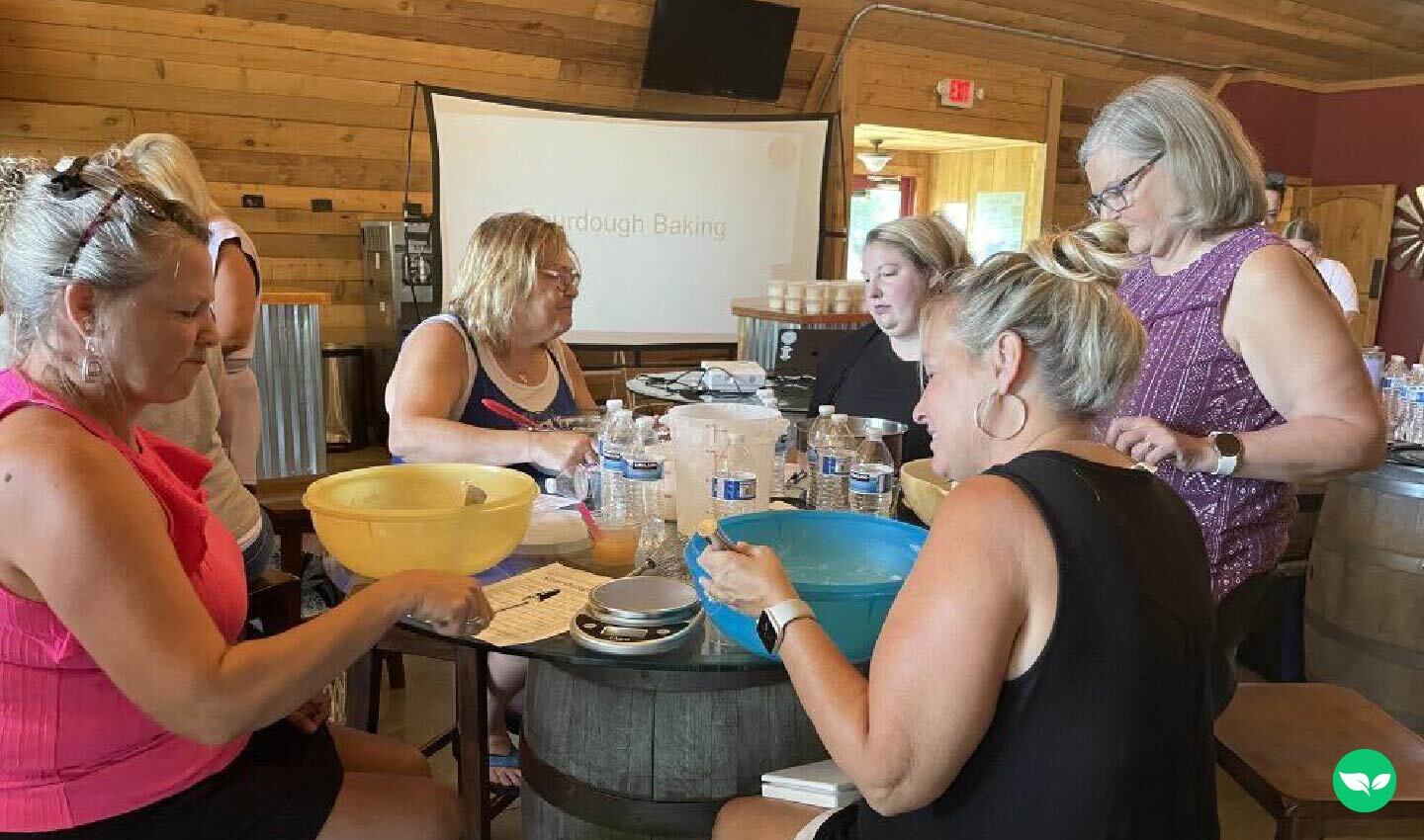 Guests measuring ingredients and mixing dough during a Kansas City Sourdough class at KC Wine Co.